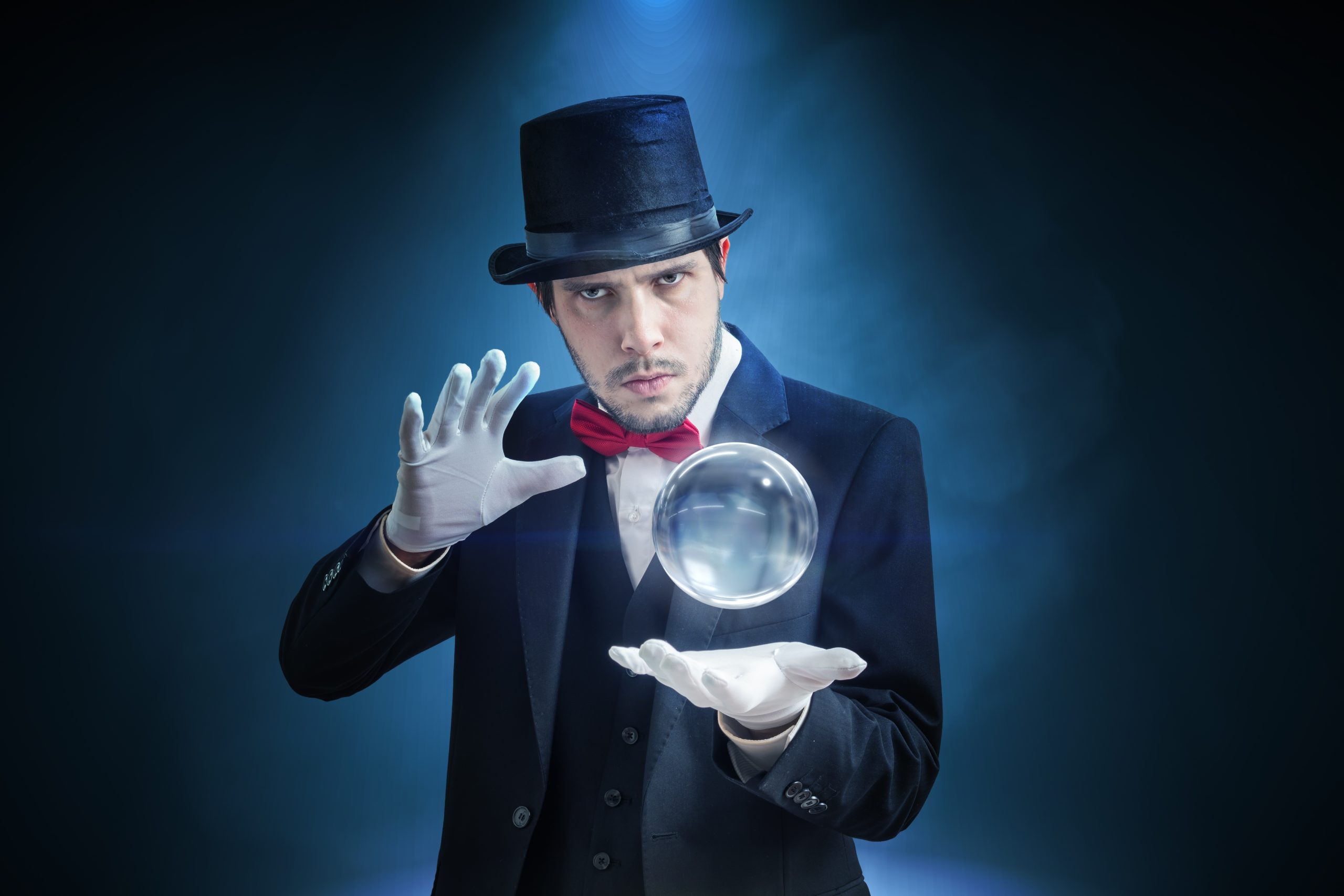 Young illusionist, magician or fortune teller is predicting future with crystal sphere.
